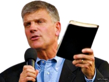 NEW YORK - JUNE 25: Franklin Graham, with Bible in hand, addresses the crowd before his father Billy Graham speaks during his Crusade at Flushing Meadows Corona Park June 25, 2005 in the Queens borough of New York. Flushing Meadows Corona Park is the site for Graham's sermons on June 24-26, which looks to draw thousands of people from across the country, and will purportedly be the aging Christian evangelist's final crusade. (Photo by Stephen Chernin/Getty Images)